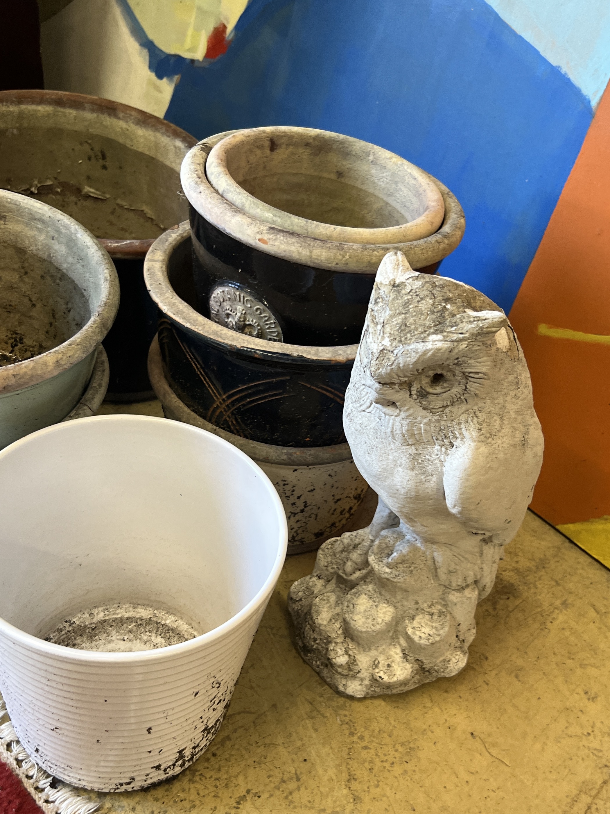 Ten assorted planters and a reconstituted stone owl garden ornament, largest width 38cm
